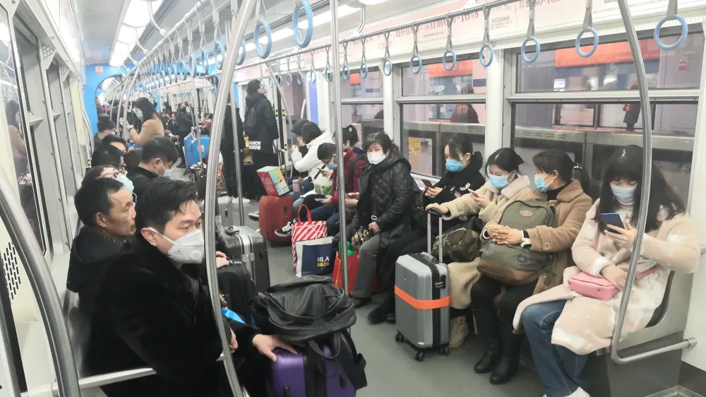 people wearing masks on china metro train.